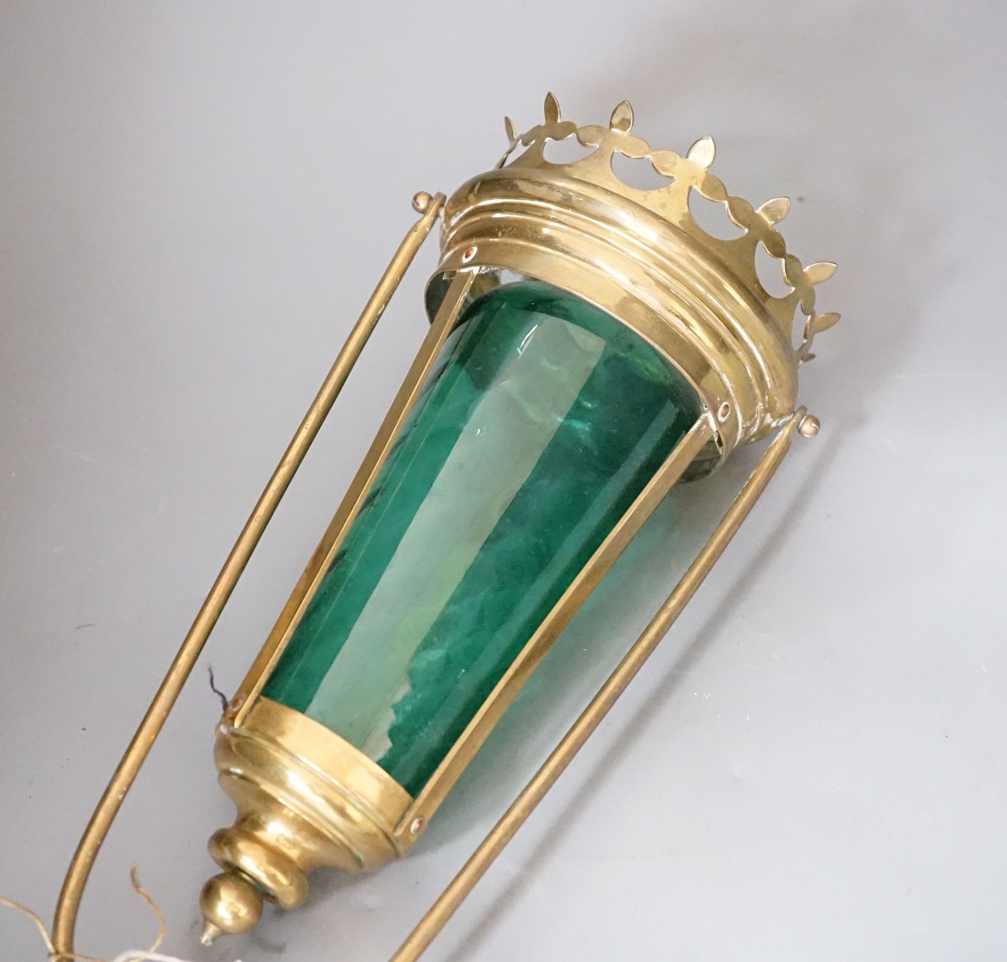 A brass and green glass processional lantern, with docking port, 90 cms high.